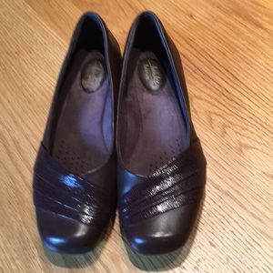 Clark’s brown flats with toe decor feature